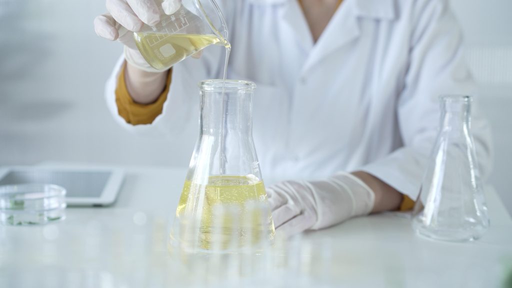 A,Scientist,,Wearing,A,Lab,Coat,And,White,Protective,Gloves,