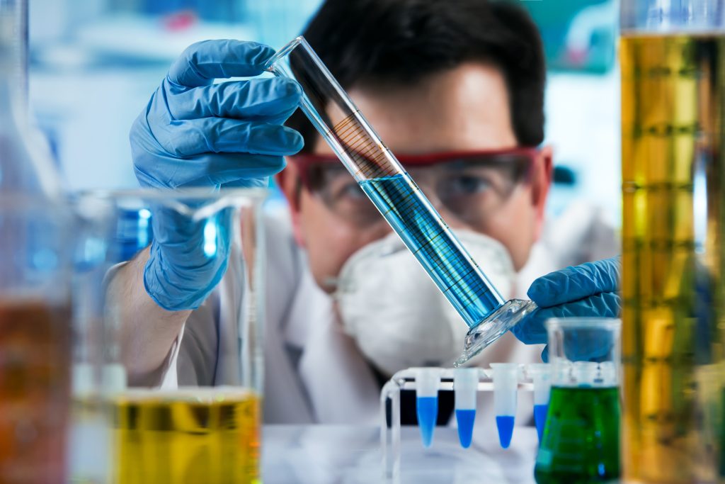Researcher,Holding,Test,Tube,With,Chemist,Material,In,The,Investigation